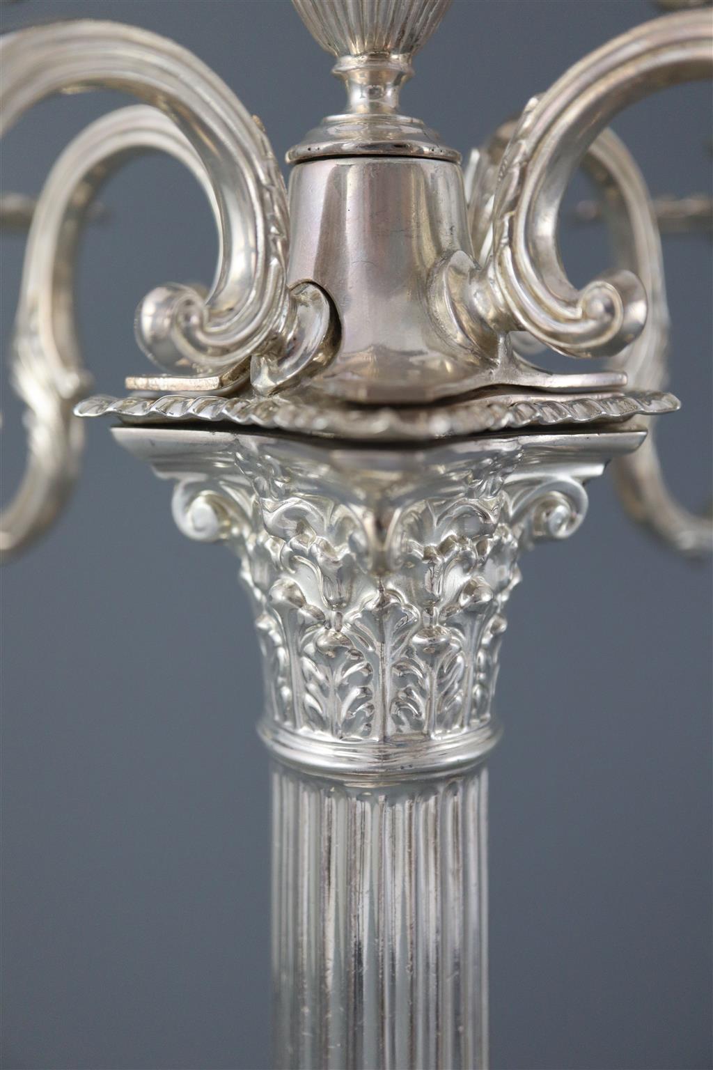 A pair of late Victorian silver corinthian column four branch, five light candelabra by Carrington & Co,
